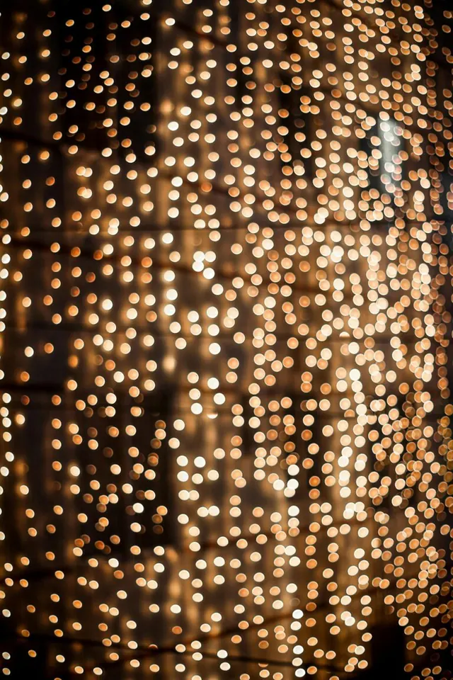 Strings of warm golden lights against a dark background.
